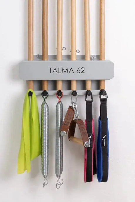  Wall-mounted HEGREN Pilates Stick Stand with 6 slots and 6 hooks for organized storage of Pilates sticks and accessories.