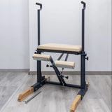  Side view of the HEGREN Pilates Chair TALMA 62CH showcasing its steel frame and beige upholstery.