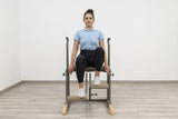  Side view of the HEGREN Pilates Chair TALMA 62CH showcasing its steel frame and beige upholstery.