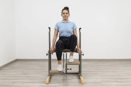  Side view of the HEGREN Pilates Chair TALMA 62CH showcasing its steel frame and beige upholstery.