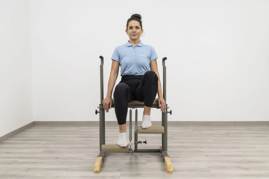  Side view of the HEGREN Pilates Chair TALMA 62CH showcasing its steel frame and beige upholstery.