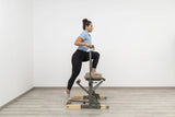  Side view of the HEGREN Pilates Chair TALMA 62CH showcasing its steel frame and beige upholstery.