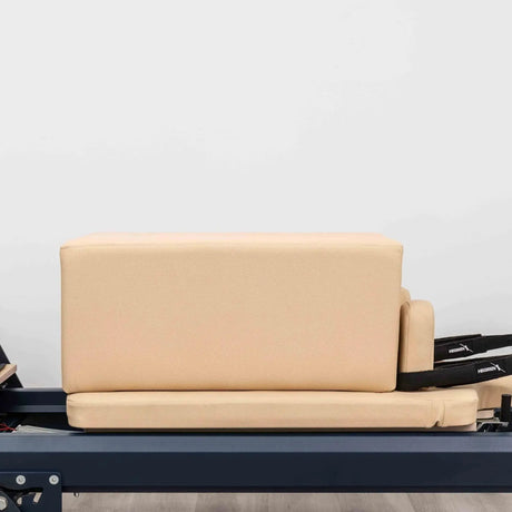 HEGREN Box Modern placed on a Pilates Reformer, showcasing its cushioned surface and modern design.