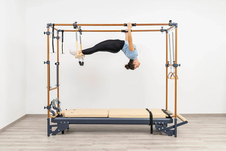 Side view of the HEGREN Cadillac Reformer TALMA 62CR showcasing its steel frame and beige upholstery.