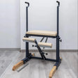  Side view of the HEGREN Pilates Chair TALMA 62CH showcasing its steel frame and beige upholstery.
