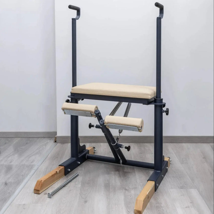  Side view of the HEGREN Pilates Chair TALMA 62CH showcasing its steel frame and beige upholstery.