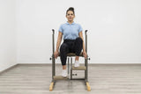  Side view of the HEGREN Pilates Chair TALMA 62CH showcasing its steel frame and beige upholstery.