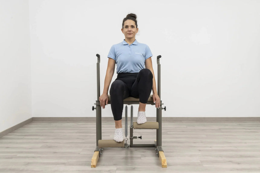  Side view of the HEGREN Pilates Chair TALMA 62CH showcasing its steel frame and beige upholstery.
