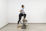 Side view of the HEGREN Pilates Chair TALMA 62CH showcasing its steel frame and beige upholstery.